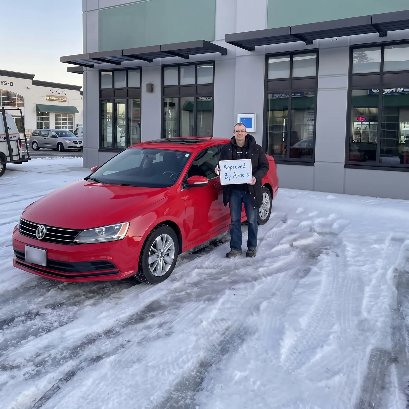 Man with his red VW Jetta in the snow